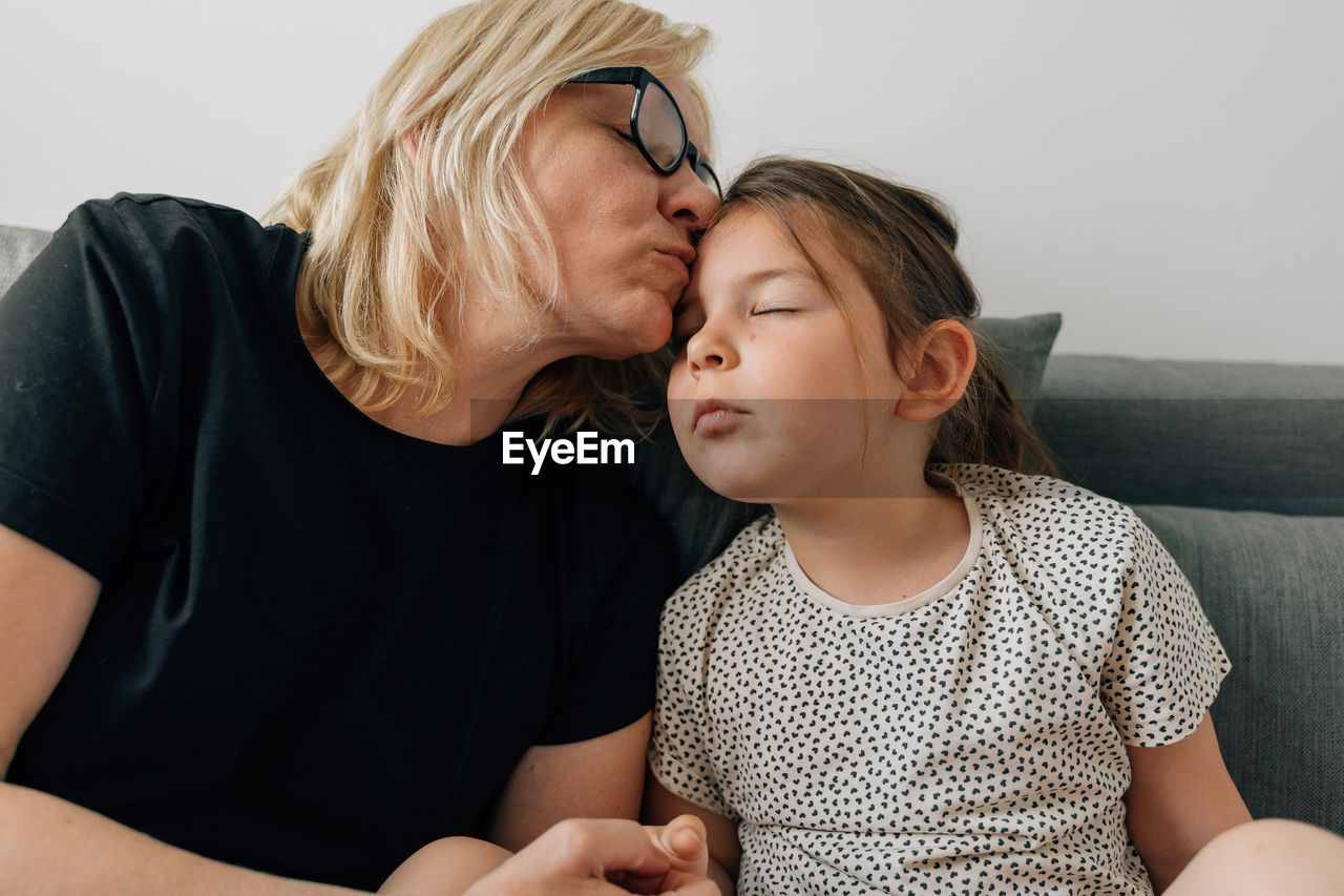 Grandmother kissing granddaughter