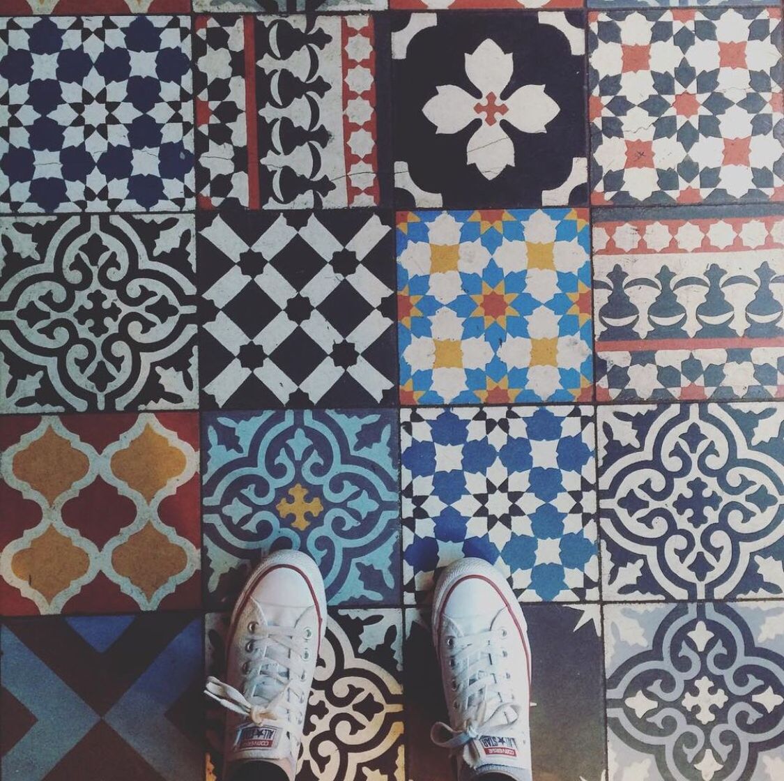 Low section of person standing on tiled floor