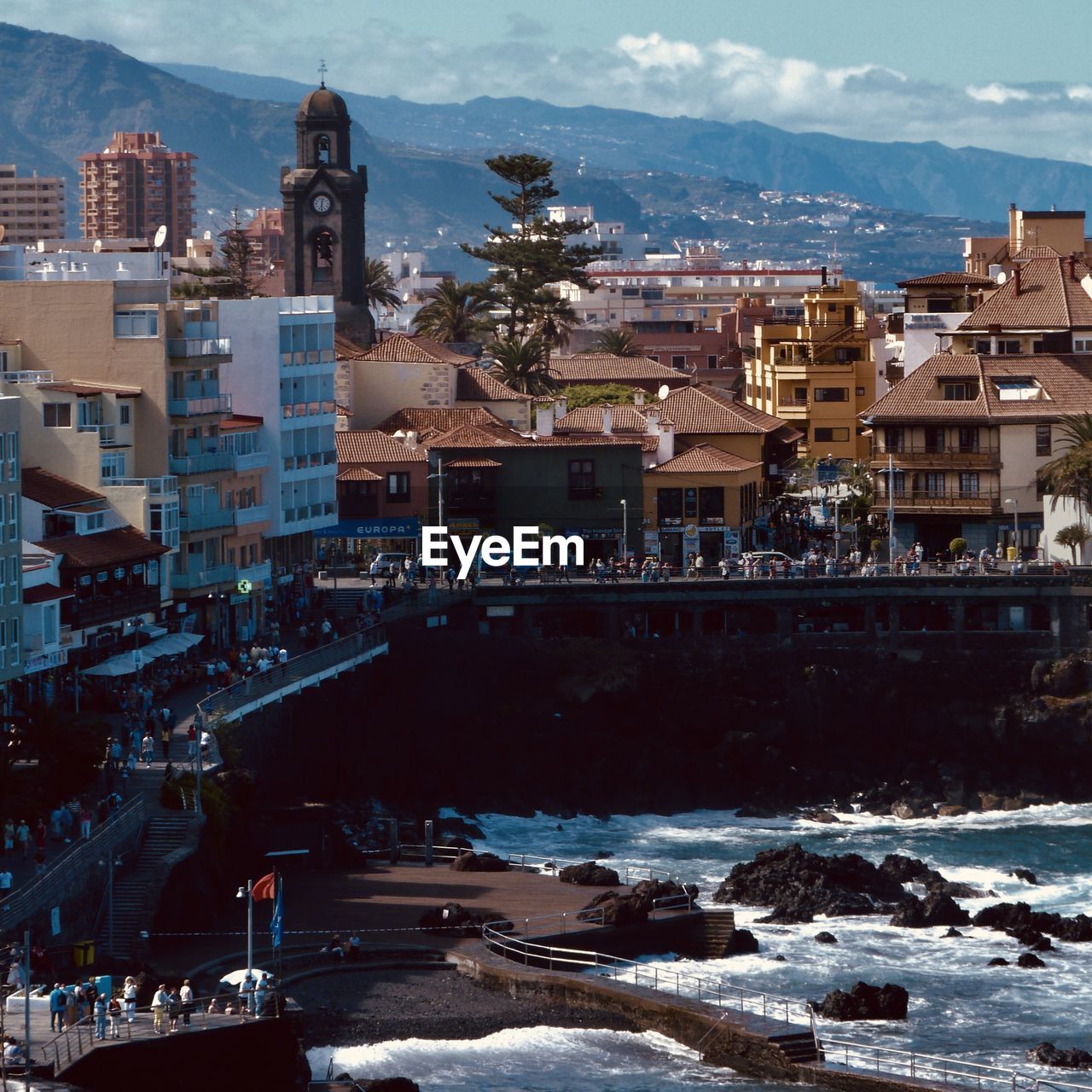 High angle view of buildings by sea against sky