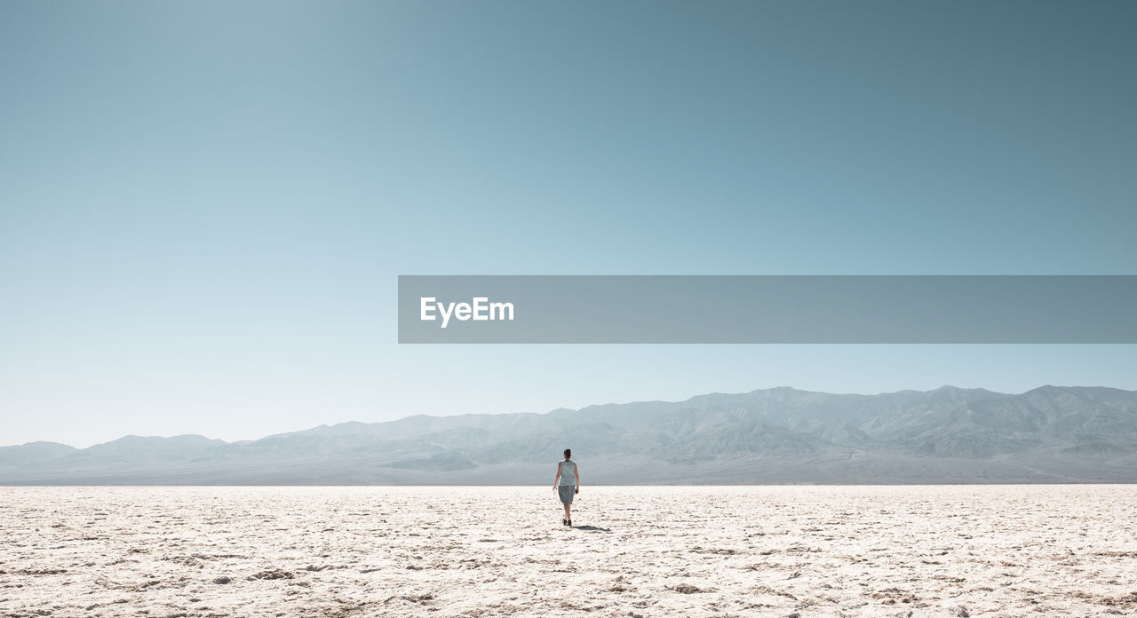 Woman on field against clear sky