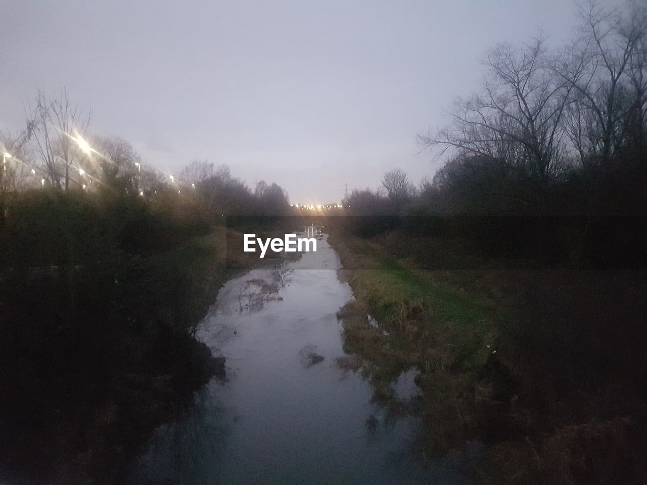 SCENIC VIEW OF RIVER AMIDST TREES AGAINST SKY DURING FOGGY WEATHER