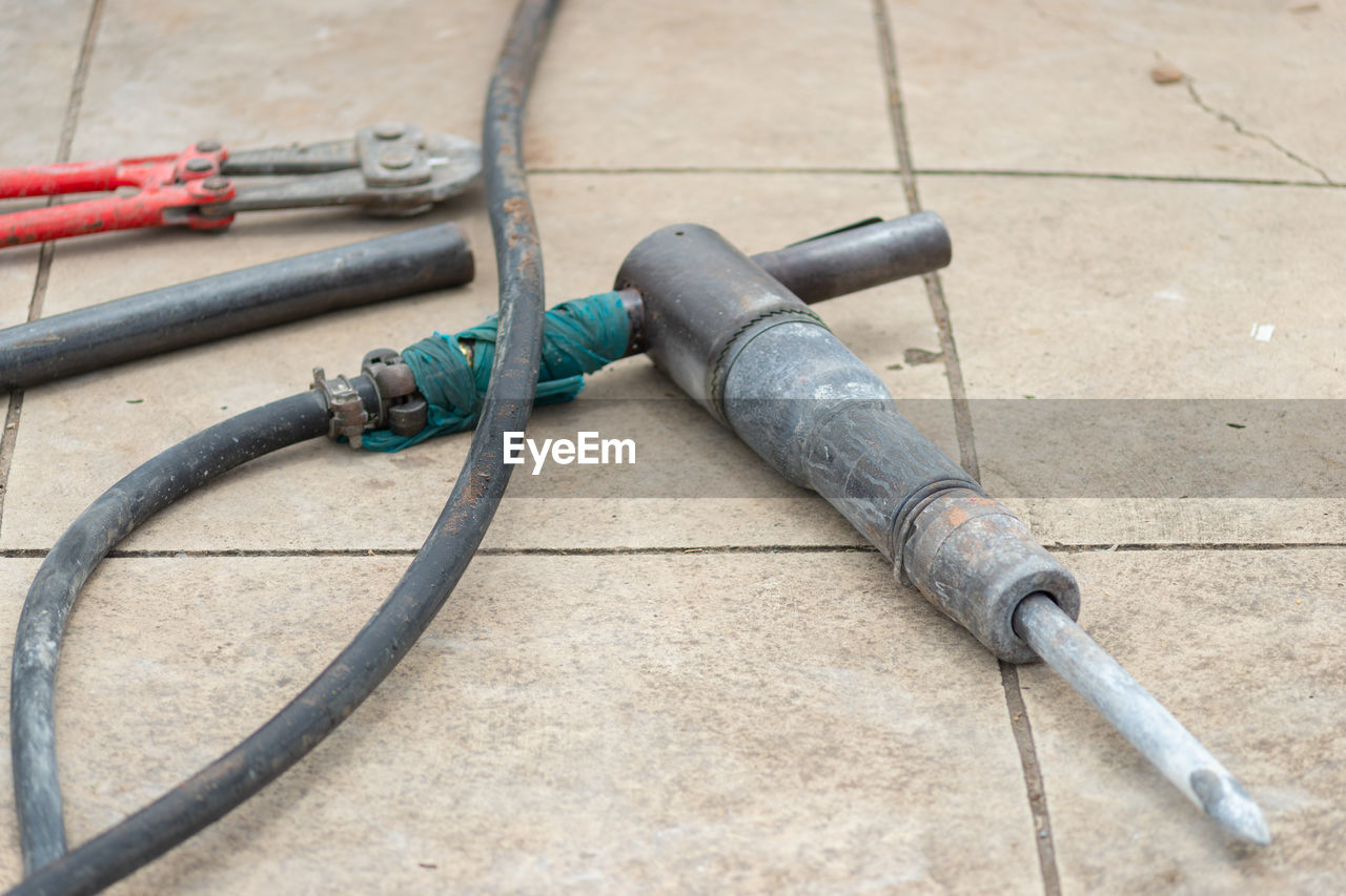 rein, no people, high angle view, iron, day, weapon, metal, hose, outdoors