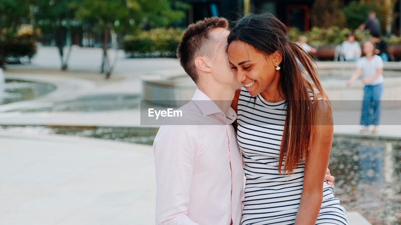 Young couple standing in swimming pool