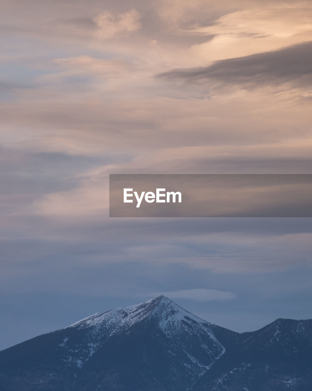 Scenic view of snowcapped mountains against sky during sunset