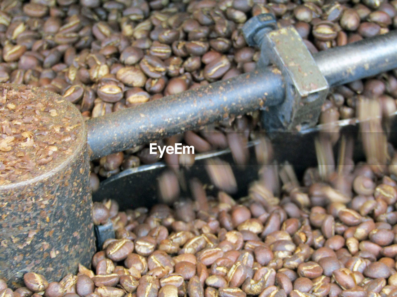 HIGH ANGLE VIEW OF ROASTED COFFEE BEANS IN FACTORY