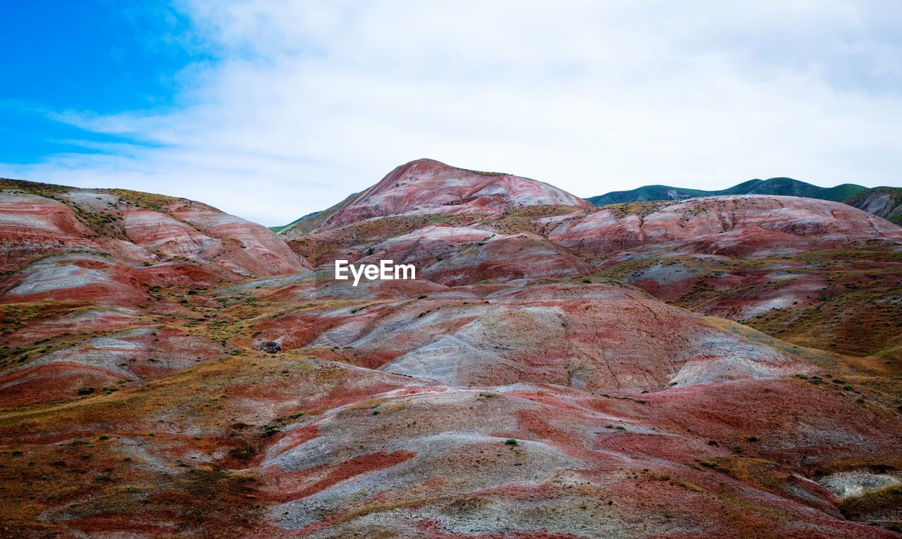 VIEW OF MOUNTAIN RANGE AGAINST CLOUDY SKY