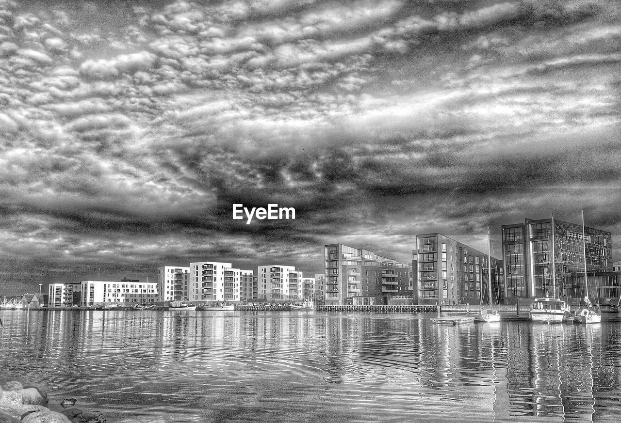 CITY SKYLINE AGAINST CLOUDY SKY