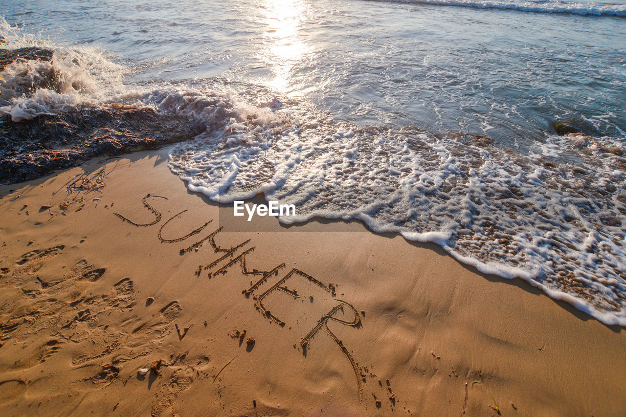 High angle view of text at beach