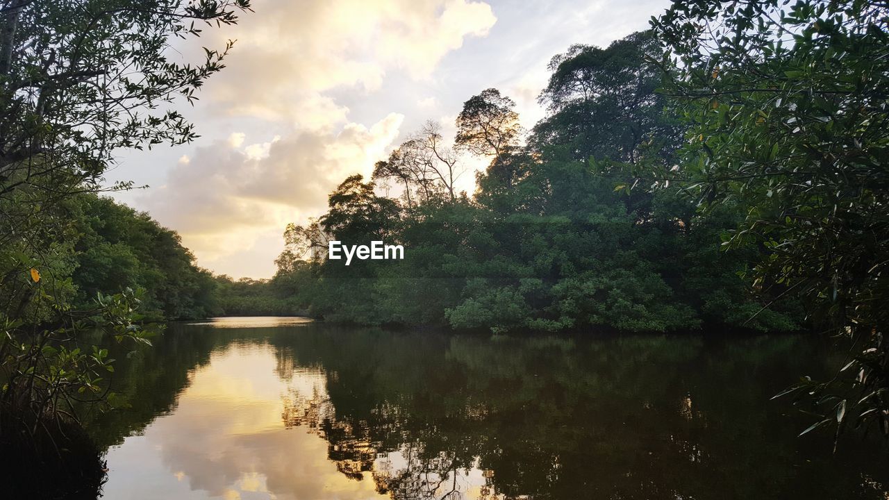 Scenic view of lake against cloudy sky