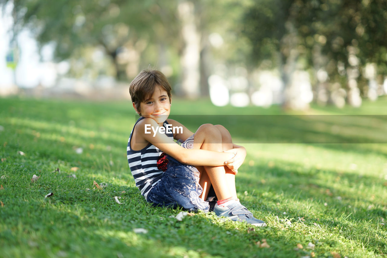 Portrait of smiling girl sitting on grass