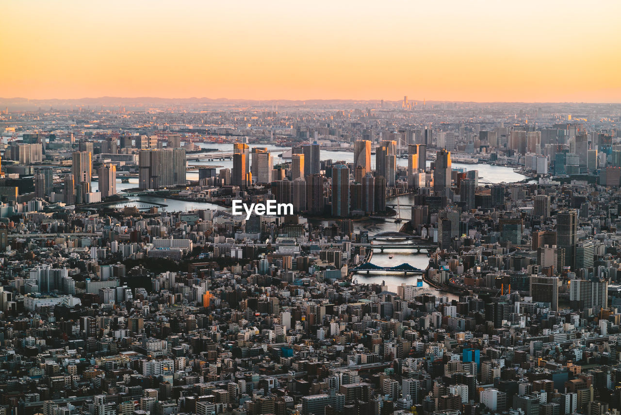 Aerial view of city against sky during sunset