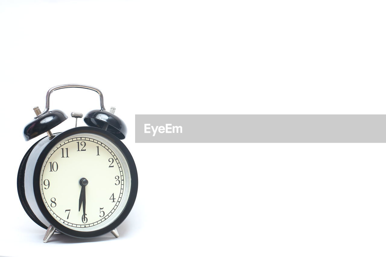 Close-up of alarm clock on white background