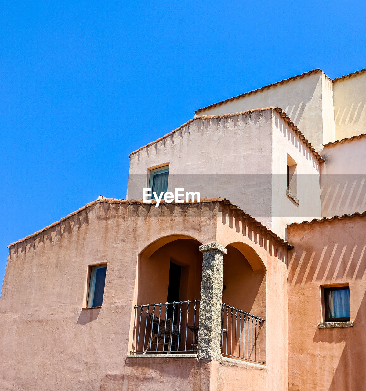 Low angle view of old building against clear blue sky