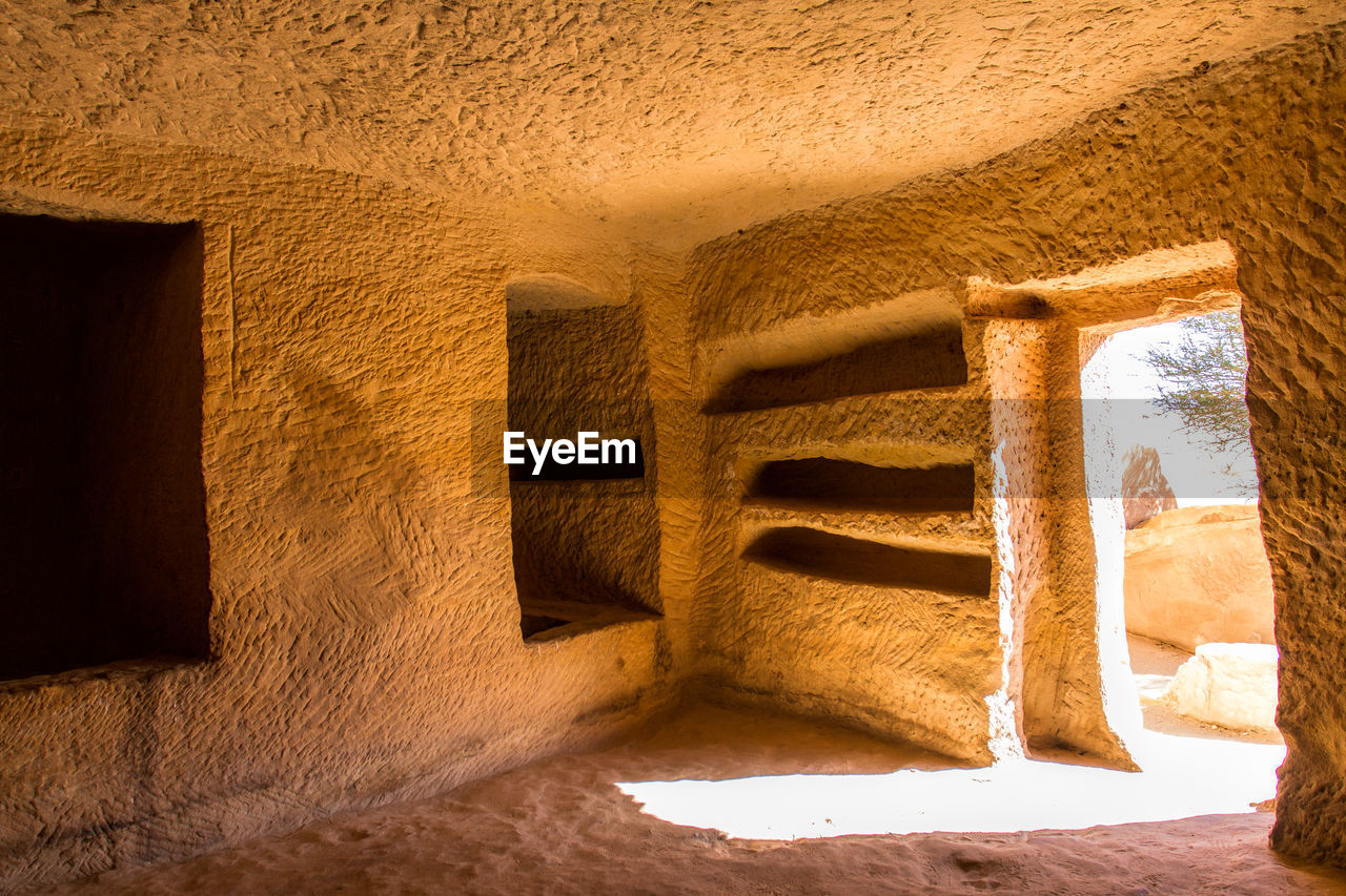architecture, wall, temple, built structure, history, ancient history, ancient, no people, the past, arch, building, wall - building feature, sunlight, nature, entrance, wood, travel destinations, building exterior, travel, old, outdoors, door, cave, stone material, day, shadow, tourism, old ruin, light, doorway