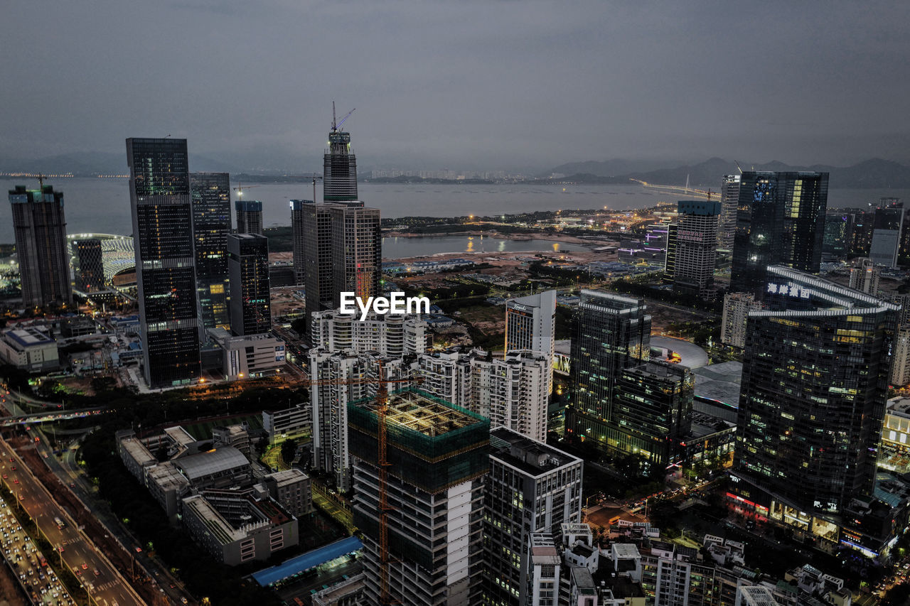 High angle view of illuminated cityscape against sky at dusk