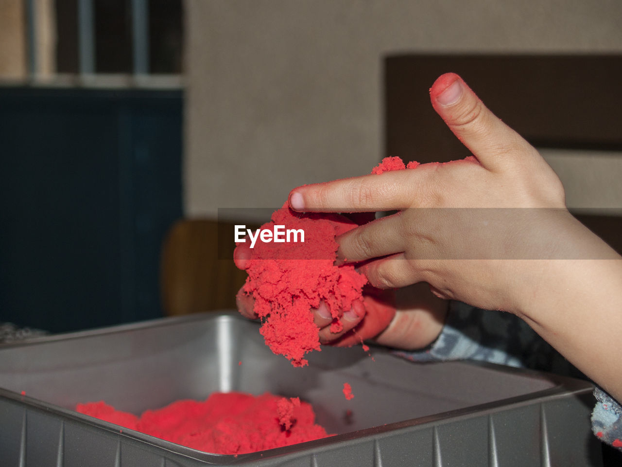 Cropped image of hands holding powder paint