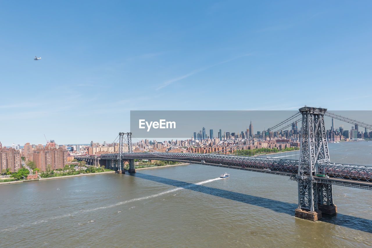 VIEW OF SUSPENSION BRIDGE OVER RIVER