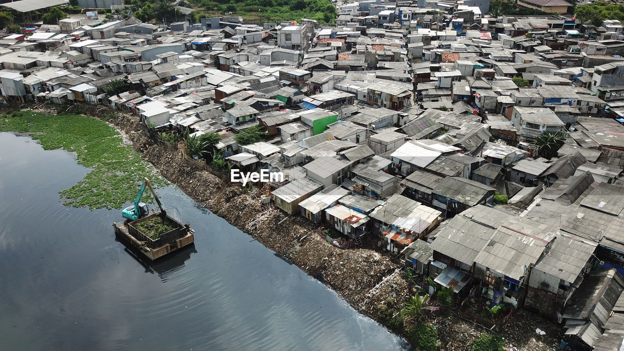 High angle view of river amidst houses in city