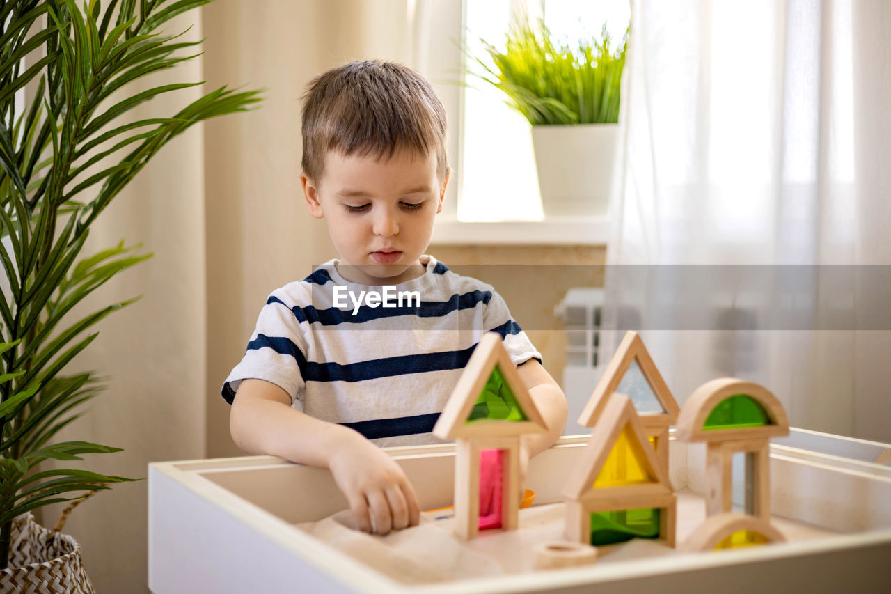 portrait of cute girl playing with toy blocks