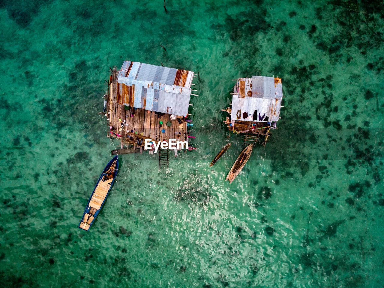 High angle view of stilt houses and boats on sea
