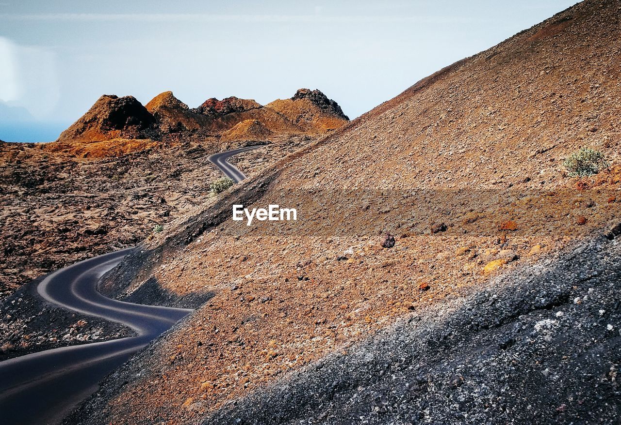 Scenic view of mountain road against sky