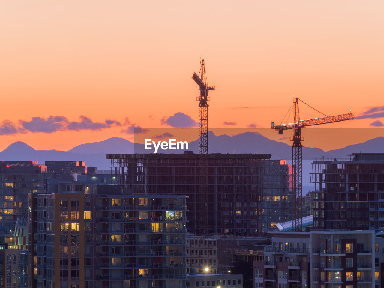 CONSTRUCTION SITE AGAINST SKY DURING SUNSET