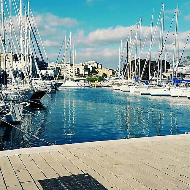 VIEW OF HARBOR AGAINST BLUE SKY AND CLOUDS