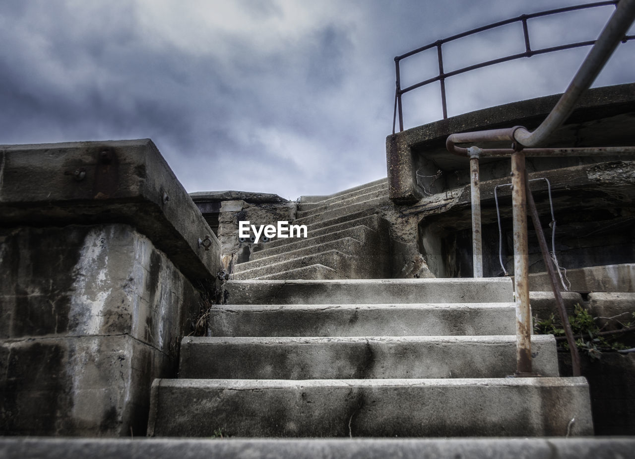 LOW ANGLE VIEW OF STAIRS AGAINST CLOUDS