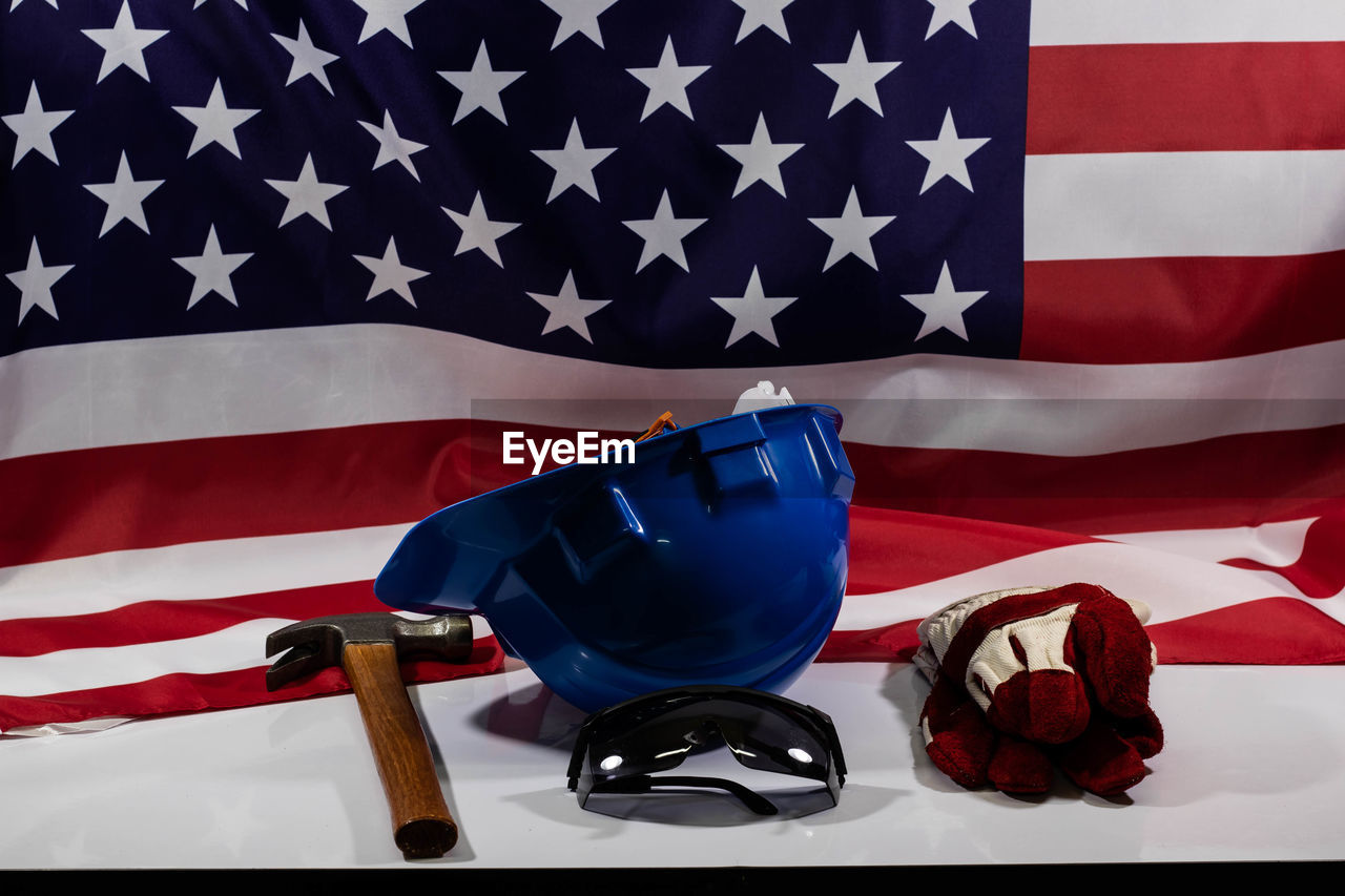 Close-up of tools by american flag