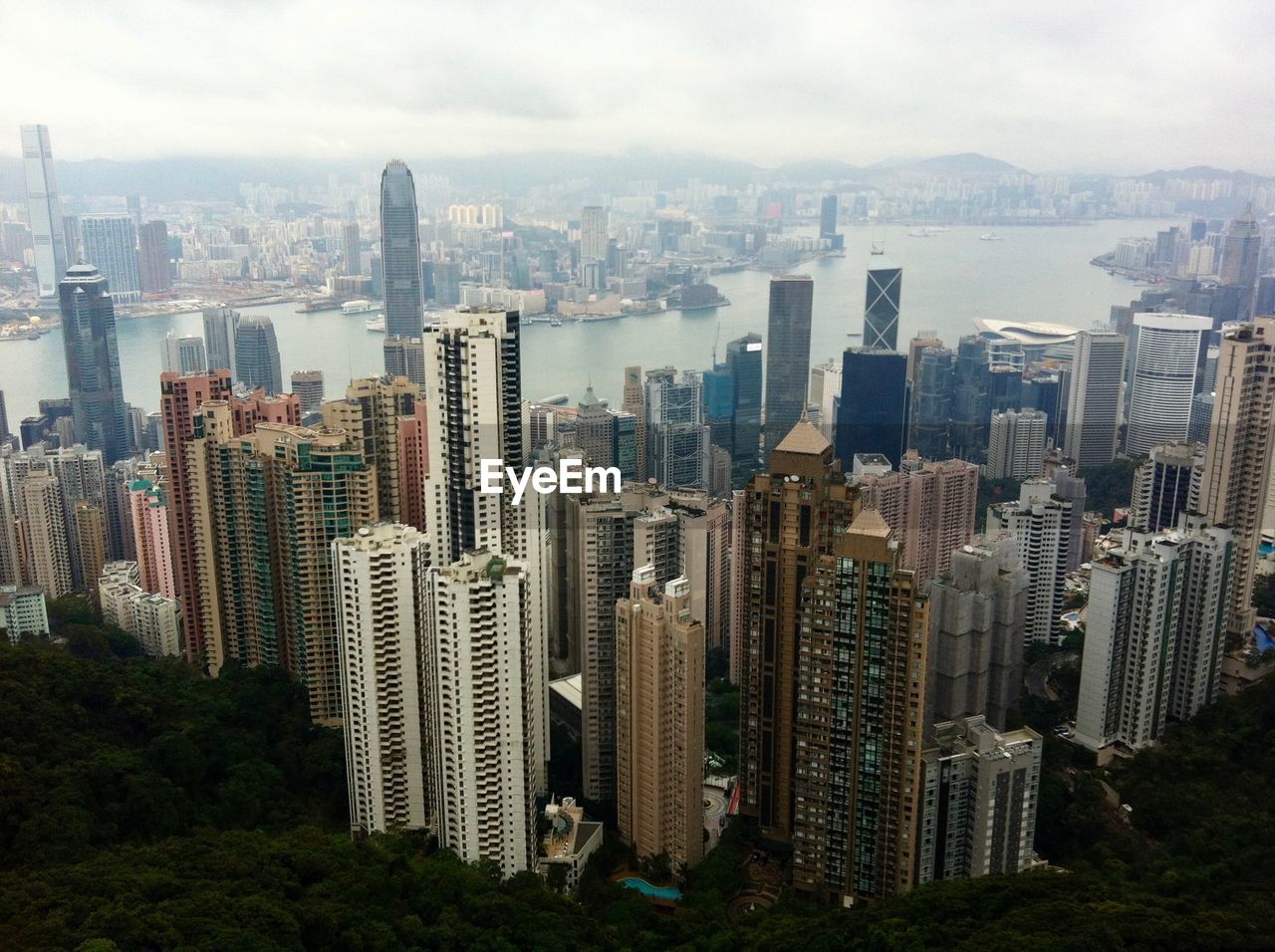 Aerial view of buildings in city against sky