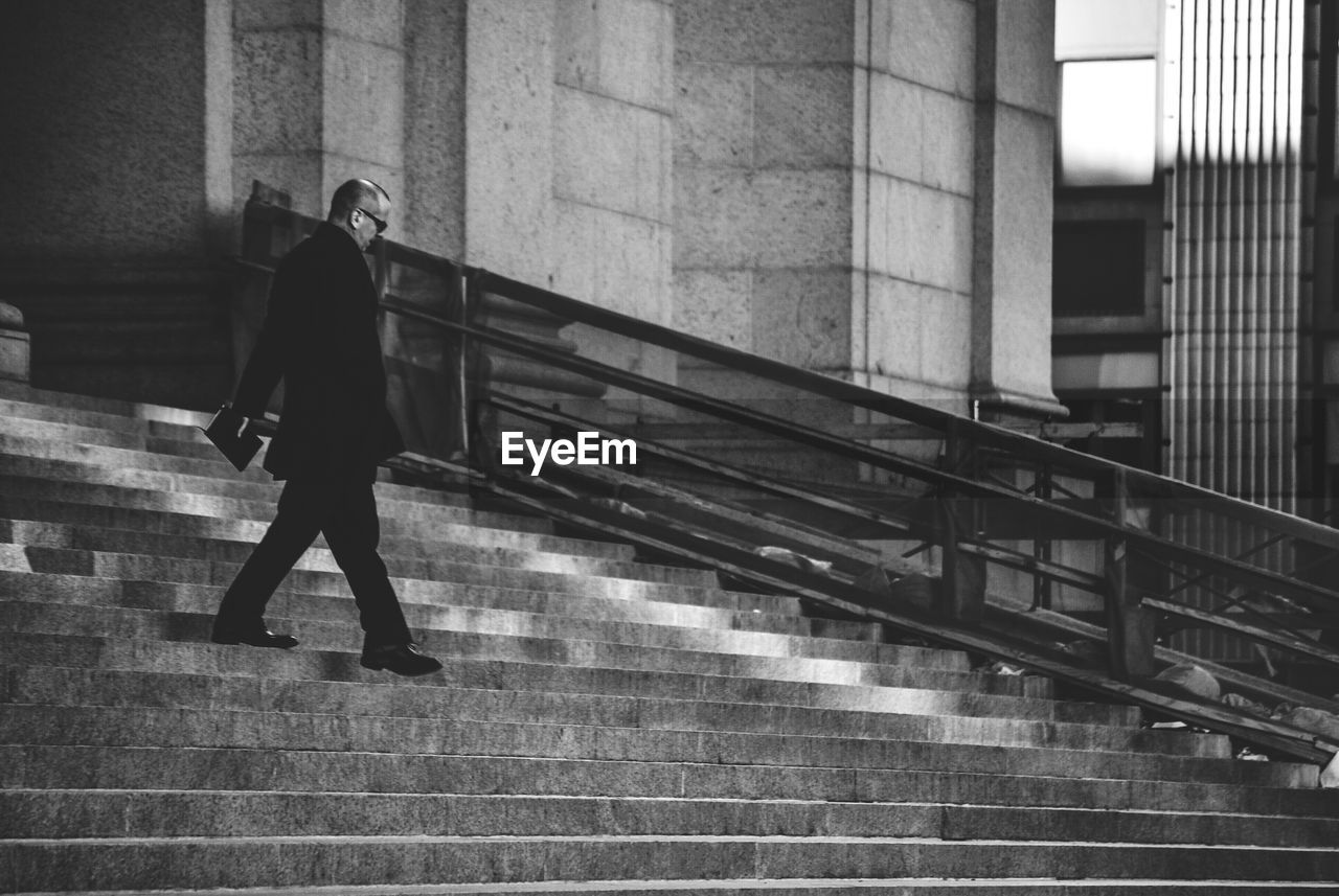 Man wearing sunglasses moving down on steps