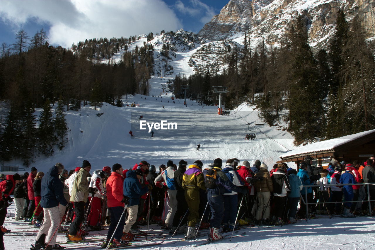 Skierswaiting to board a chailift in cortina, italy.