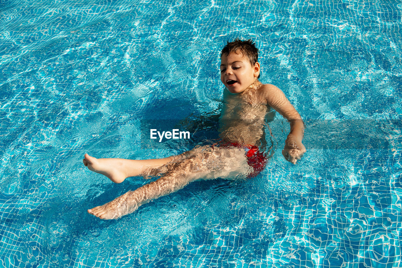 Boy swimming in pool