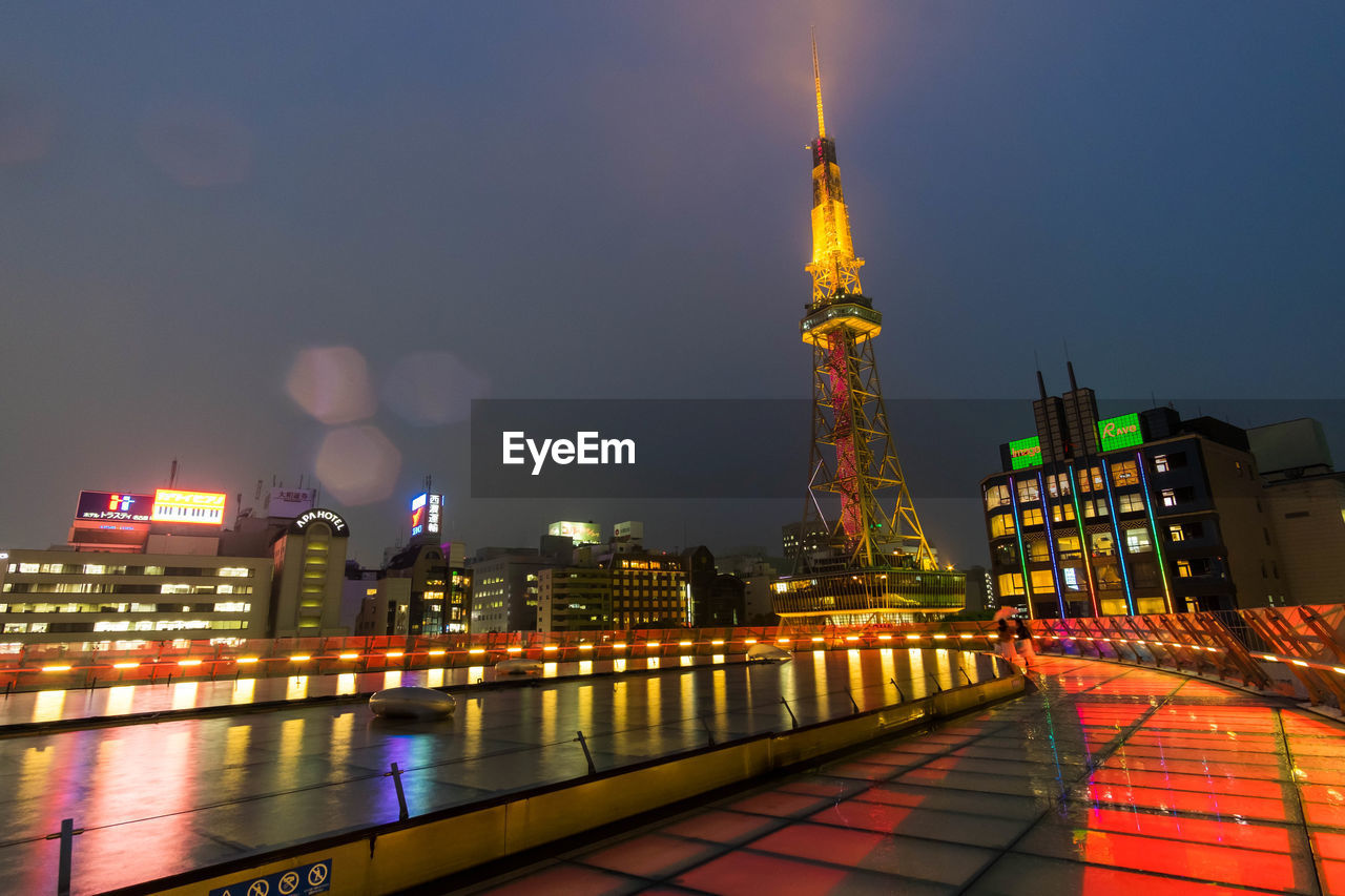 ILLUMINATED CITY BUILDINGS AT NIGHT