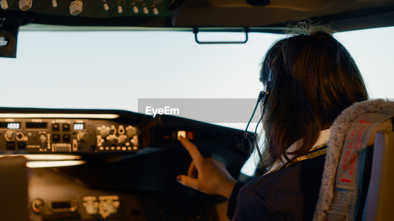 low angle view of woman holding hands in car