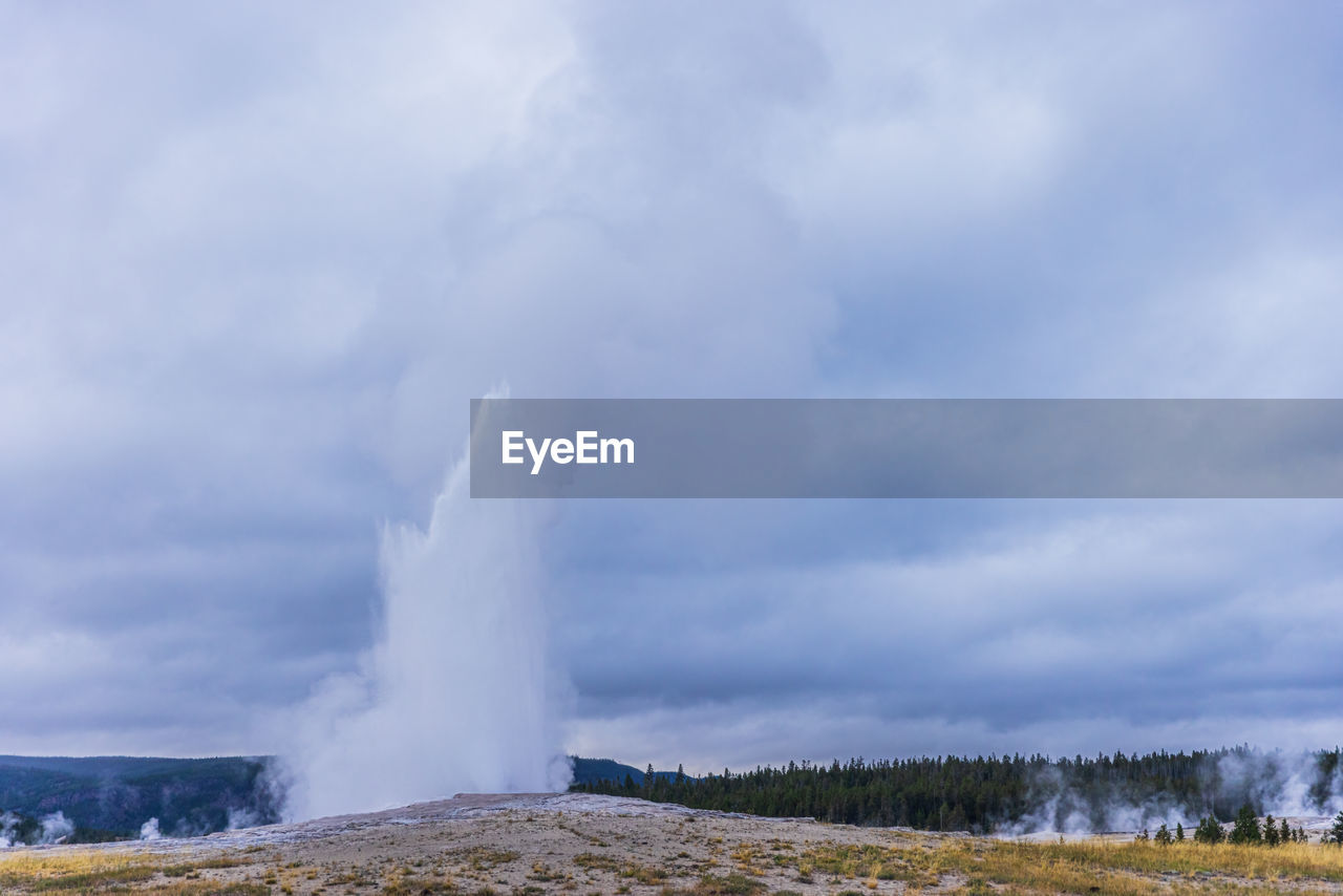 PANORAMIC VIEW OF GEYSER AGAINST SKY