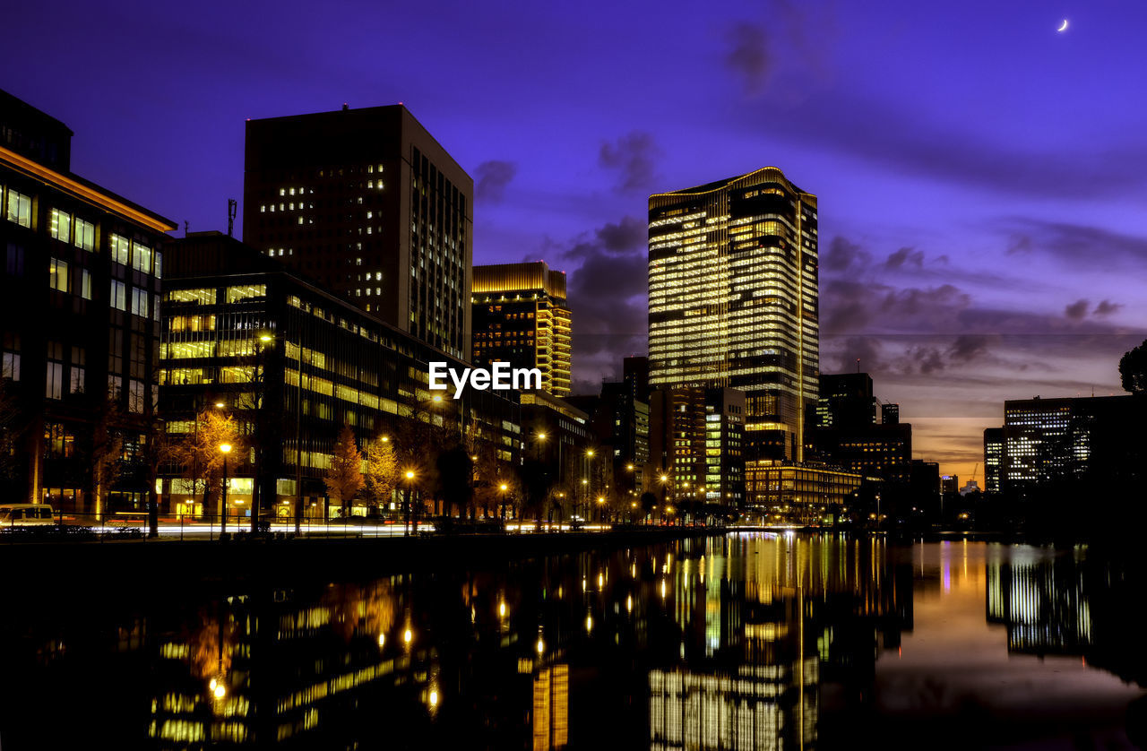 ILLUMINATED BUILDINGS AGAINST SKY AT NIGHT