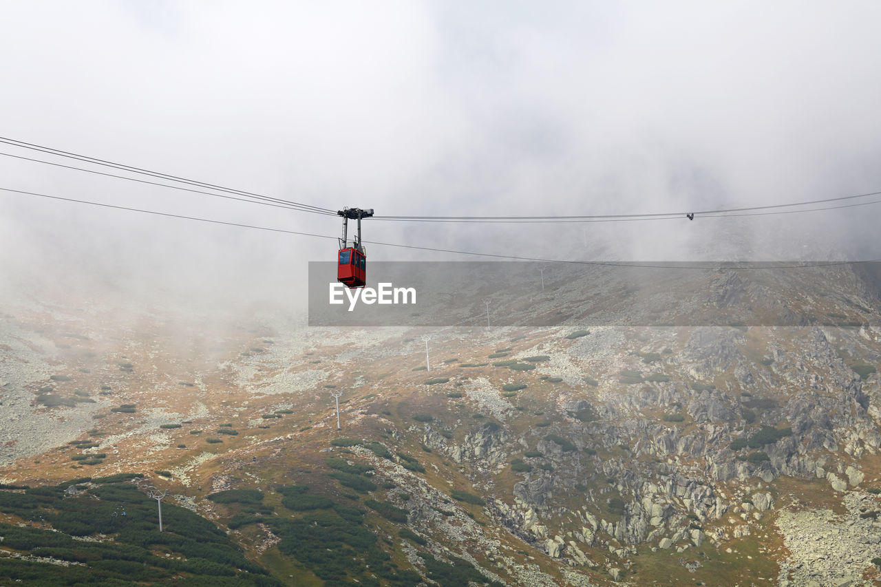 Low angle view of cable car against lomnicky peak