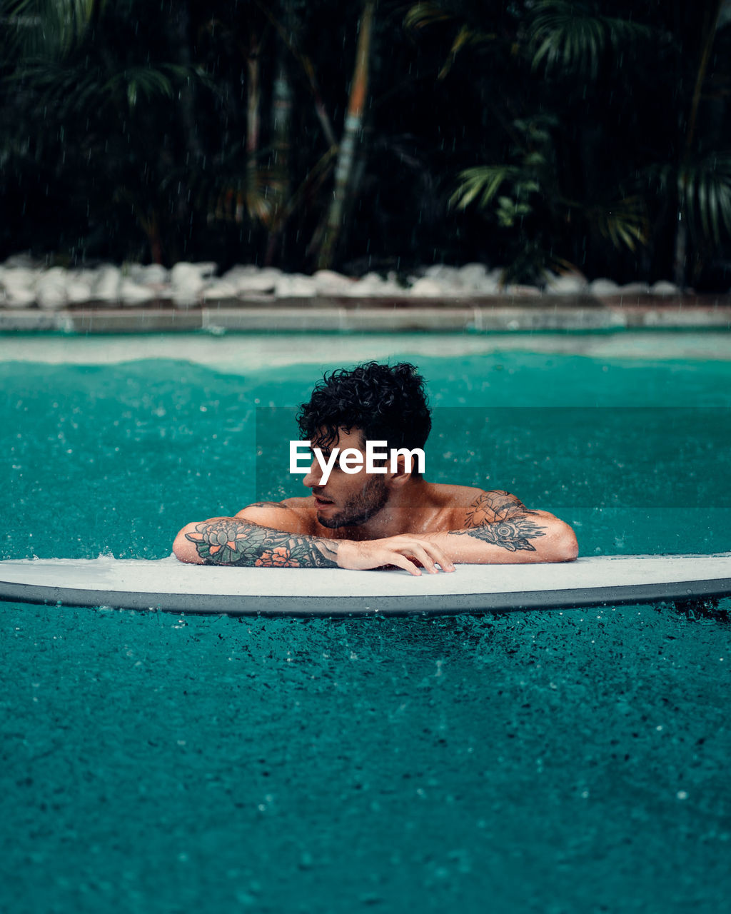 Young man swimming in pool