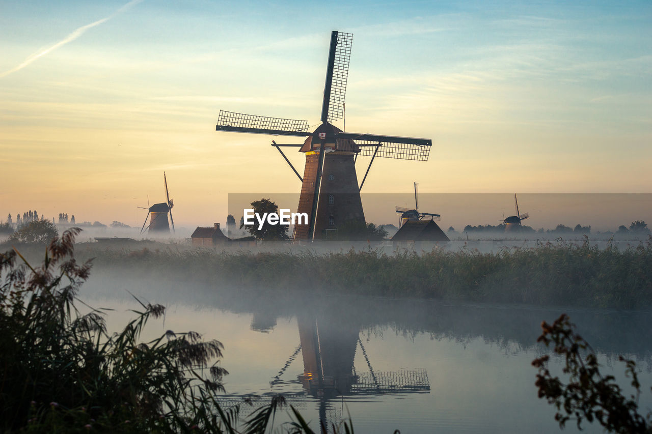 Scenic view of lake against sky during sunset, windmill, kinderdijk