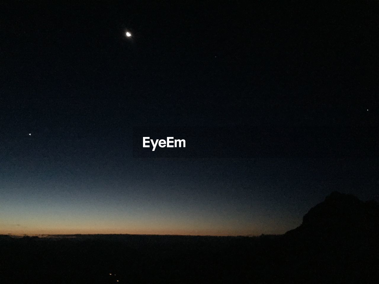 LOW ANGLE VIEW OF MOON IN SKY