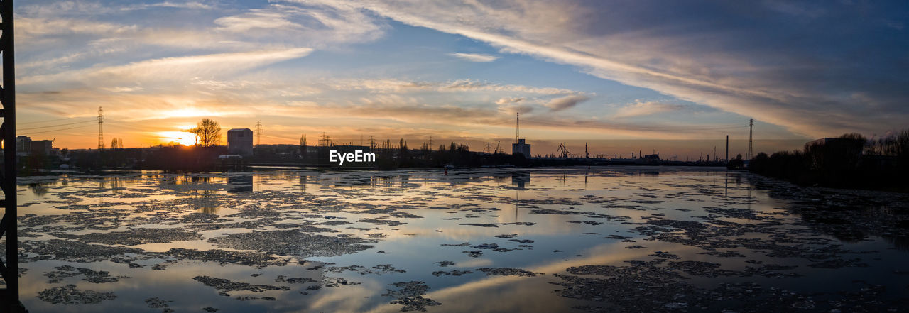 Scenic view of river at sunset