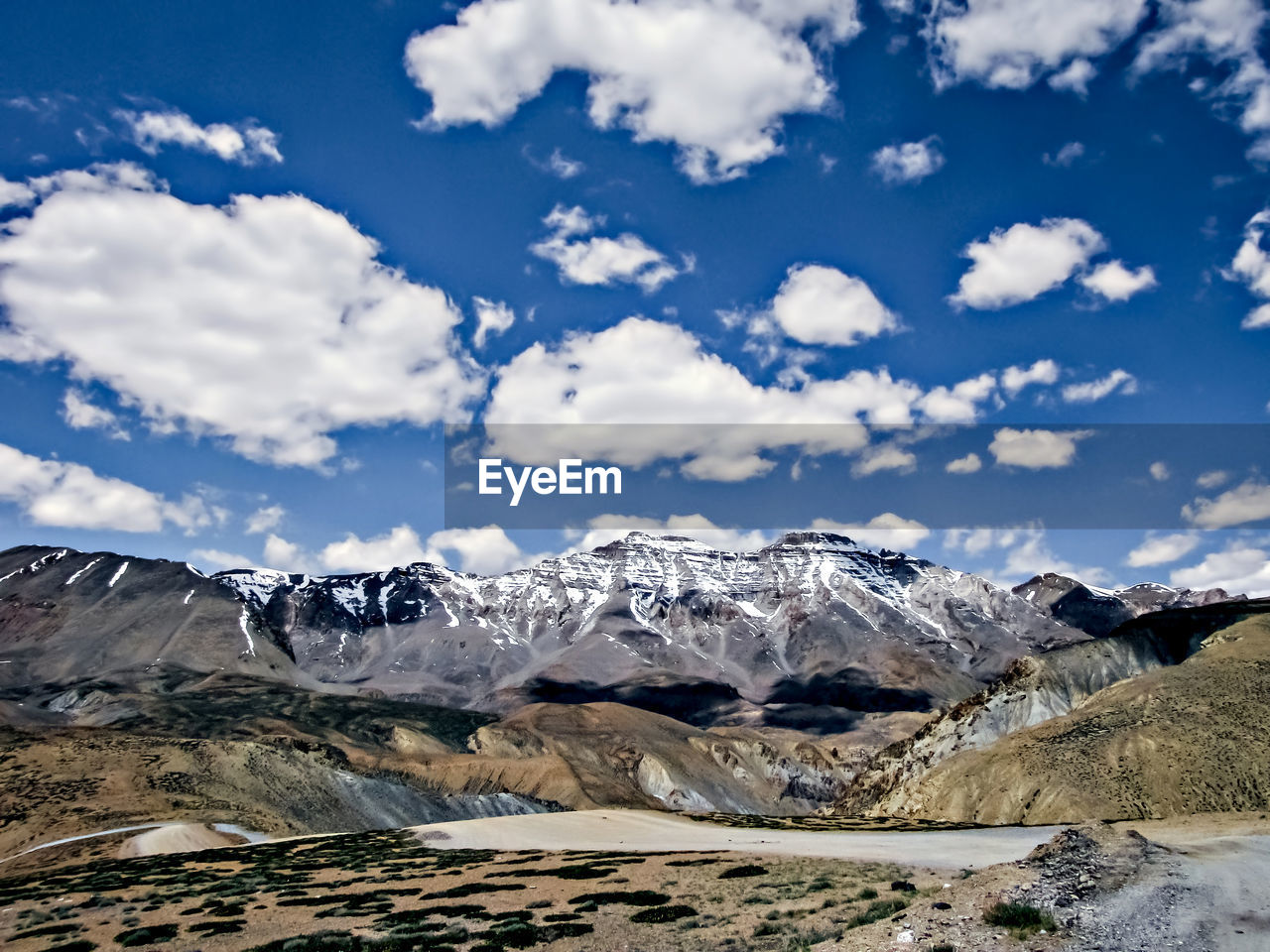 mountain, environment, sky, landscape, cloud, scenics - nature, snow, beauty in nature, nature, mountain range, cold temperature, winter, travel, no people, travel destinations, snowcapped mountain, wilderness, tranquility, non-urban scene, tranquil scene, land, plateau, day, outdoors, rock, extreme terrain, blue, tourism, idyllic