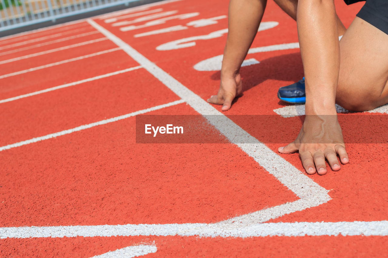 Low section of person on running track