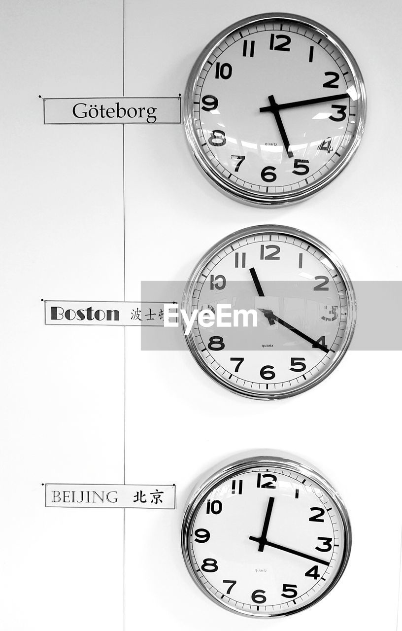 Various wall clocks with text