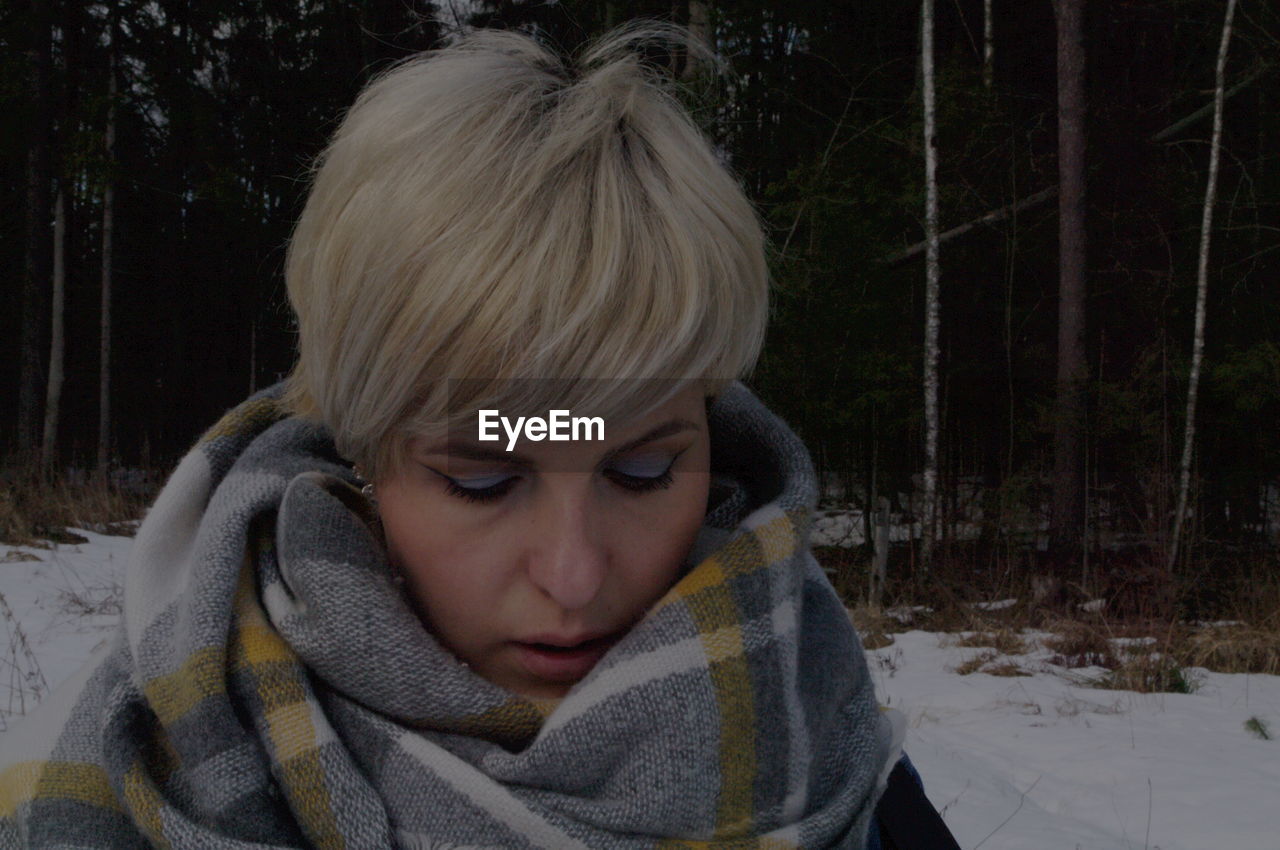 PORTRAIT OF TEENAGE GIRL IN SNOW COVERED LAND