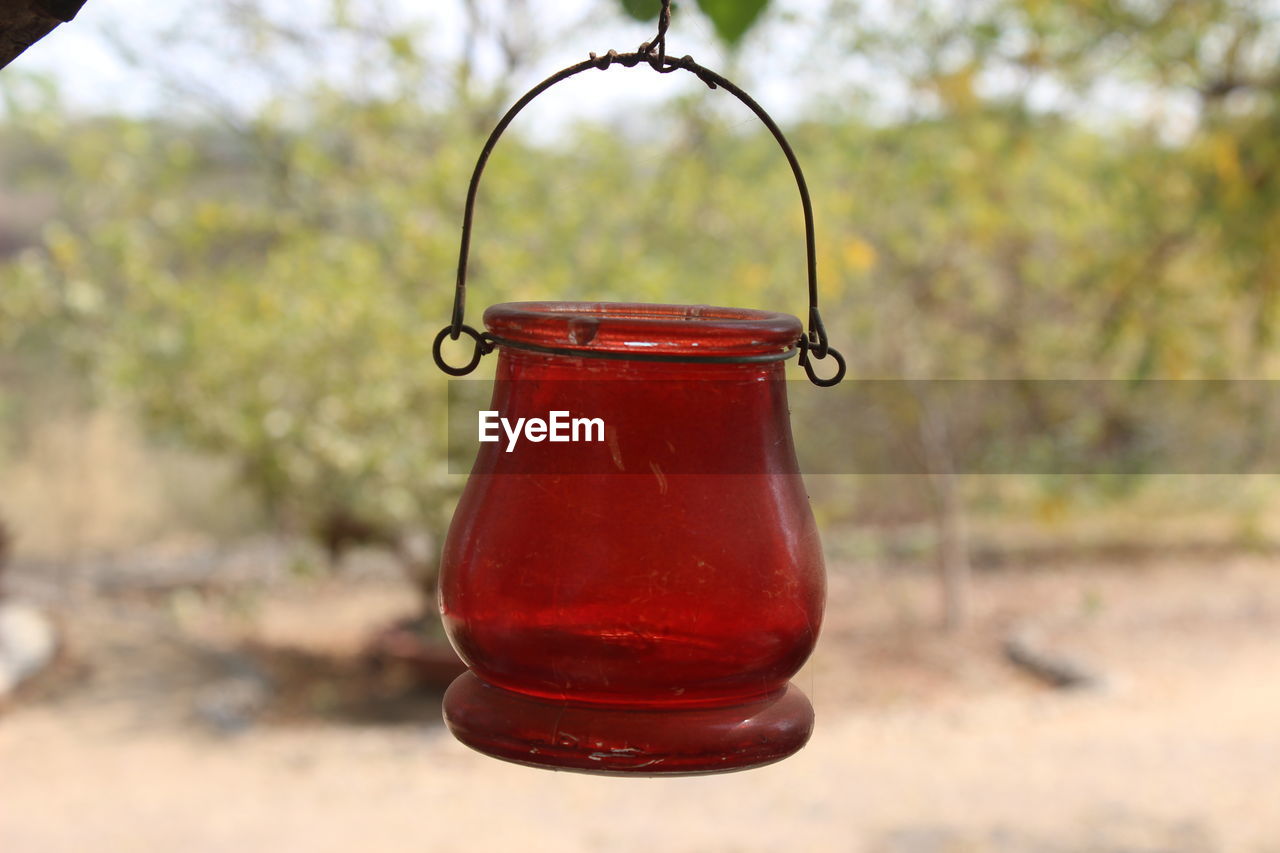 CLOSE-UP OF RED BELL HANGING