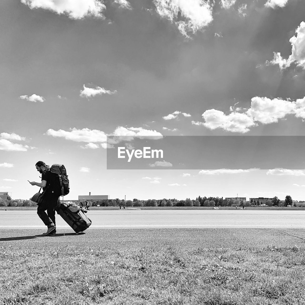 MAN RIDING BICYCLE ON FIELD