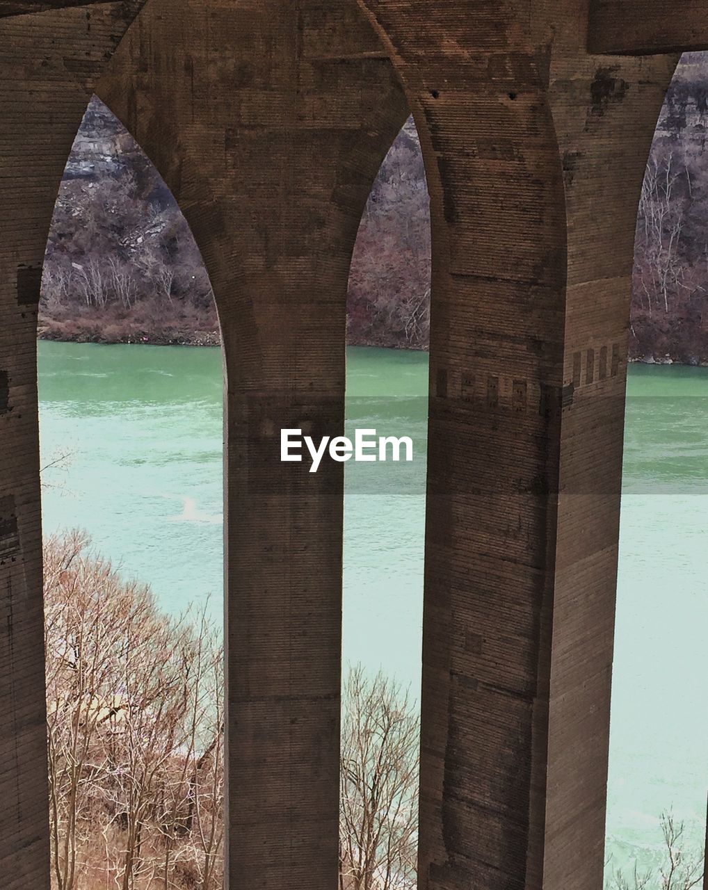 Architectural columns in corridor of historic building by river