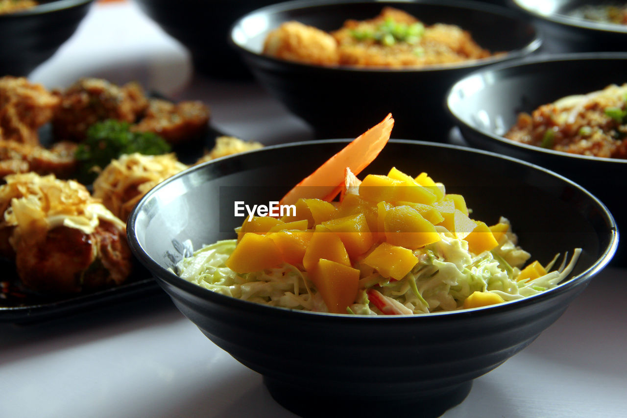 Photo of freshly made assorted japanese food on a table.